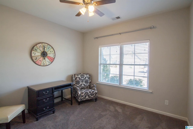 living area featuring ceiling fan and dark carpet