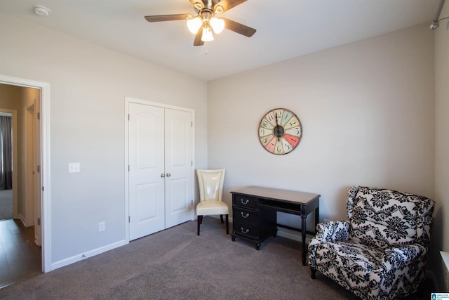 living area with ceiling fan and dark colored carpet