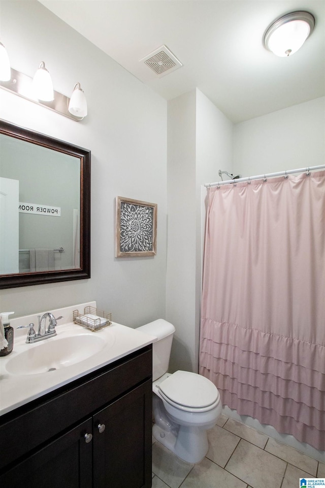 bathroom with tile patterned floors, toilet, and vanity