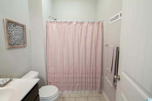 bathroom with vanity, tile patterned flooring, toilet, and walk in shower