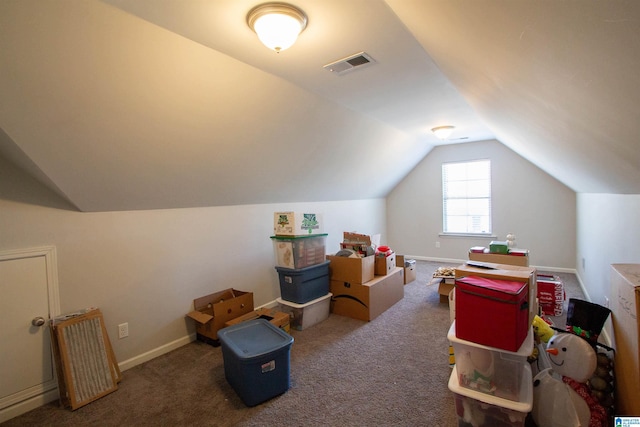 additional living space with lofted ceiling and dark colored carpet