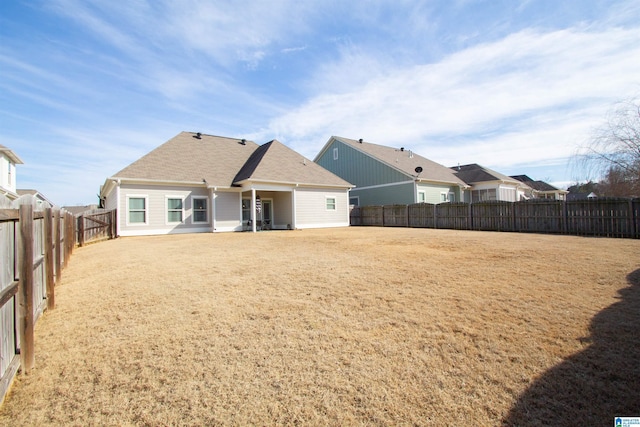 back of house with a lawn