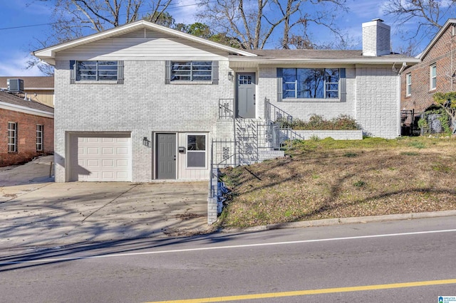 view of front of house with a garage and central AC unit