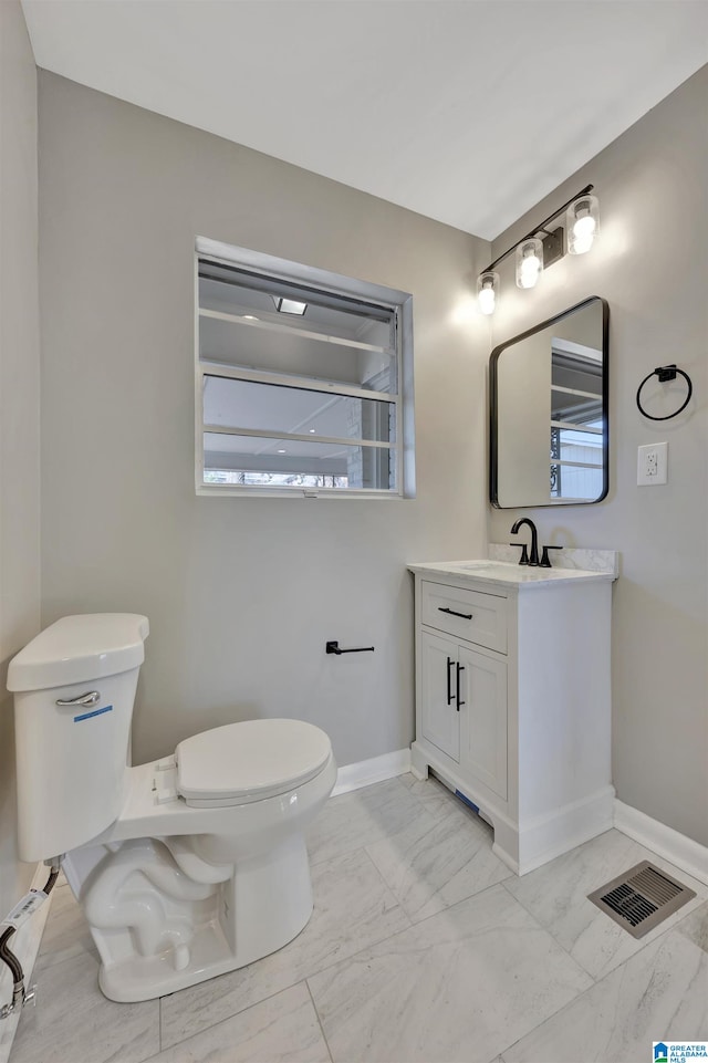 bathroom with vanity and toilet