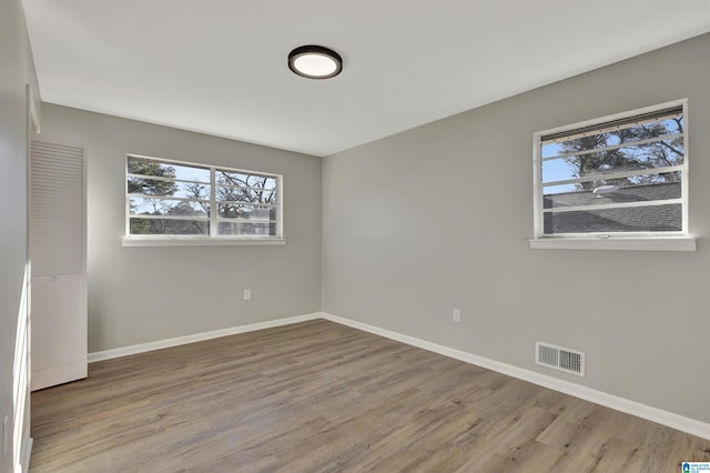 unfurnished room featuring hardwood / wood-style floors