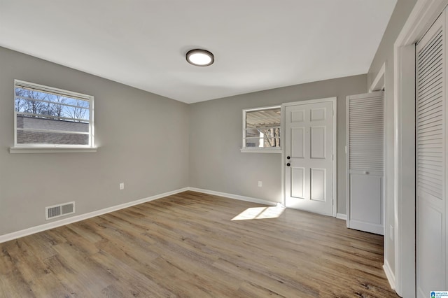 unfurnished bedroom with light wood-type flooring