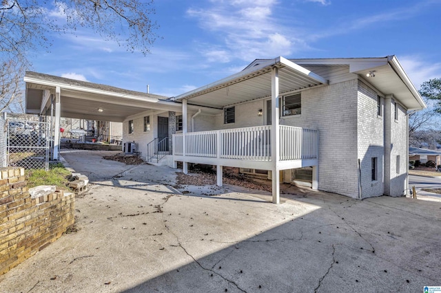 rear view of house featuring covered porch