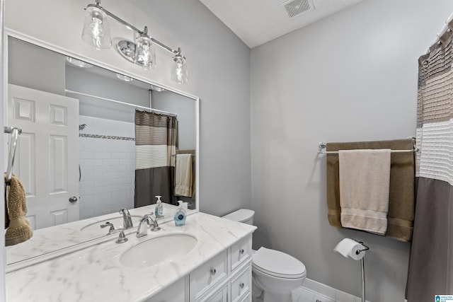 bathroom featuring walk in shower, vanity, and toilet