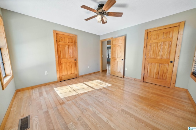 unfurnished bedroom featuring light wood-type flooring and ceiling fan