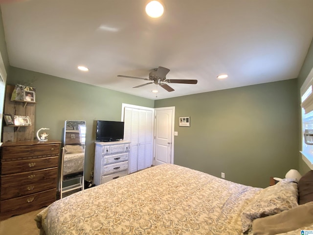 carpeted bedroom with a closet and ceiling fan