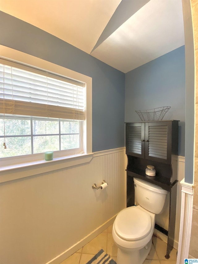 bathroom with toilet and tile patterned floors