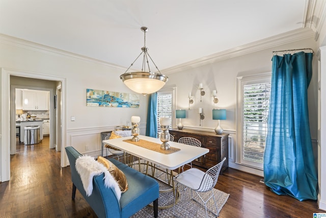 dining room with dark wood-type flooring and ornamental molding