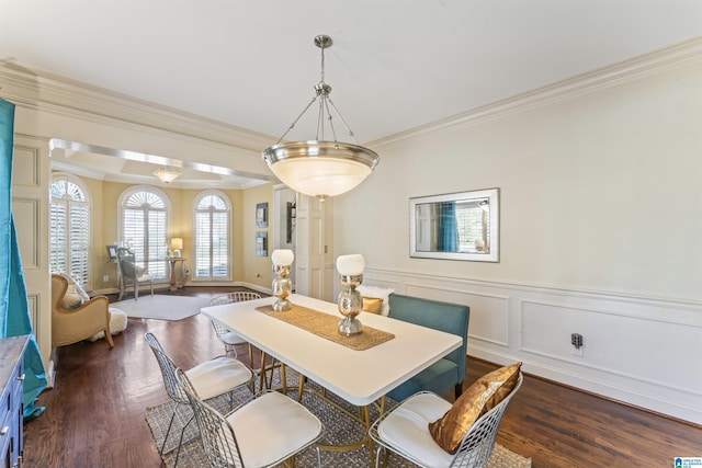 dining room with crown molding and dark hardwood / wood-style flooring