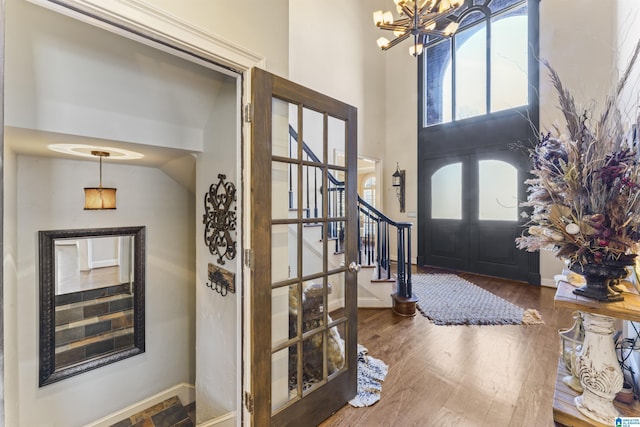 foyer featuring dark wood-type flooring and a chandelier