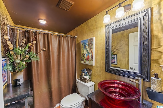 bathroom featuring sink, toilet, and walk in shower