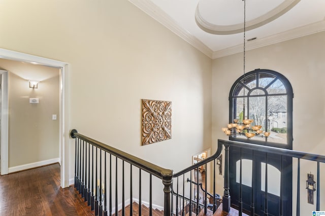 foyer entrance with crown molding, dark hardwood / wood-style flooring, and a tray ceiling