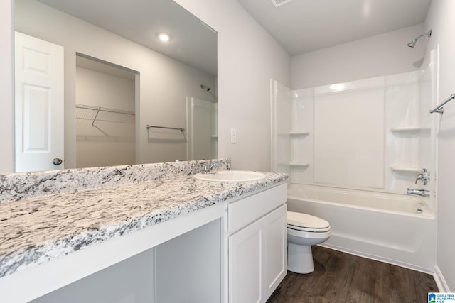 full bathroom with shower / bathtub combination, wood-type flooring, toilet, and vanity