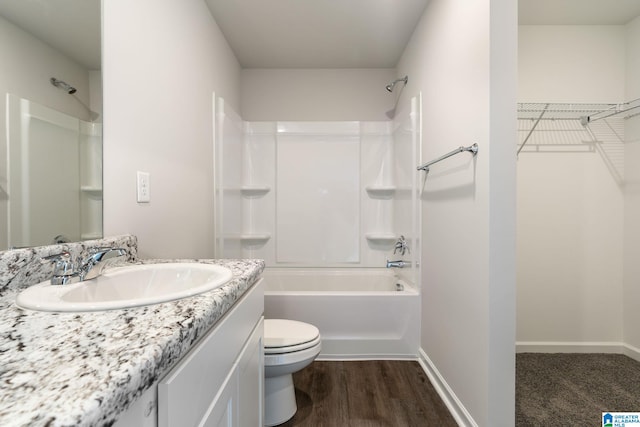 full bathroom featuring wood-type flooring, toilet, vanity, and  shower combination