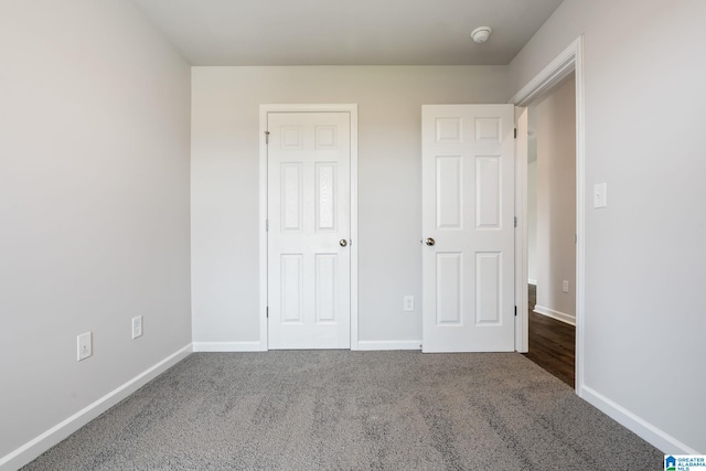 unfurnished bedroom with a closet and carpet floors