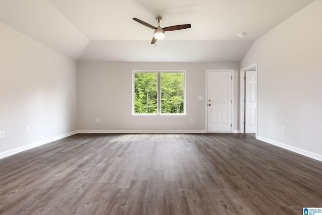 empty room featuring ceiling fan, dark hardwood / wood-style floors, and vaulted ceiling