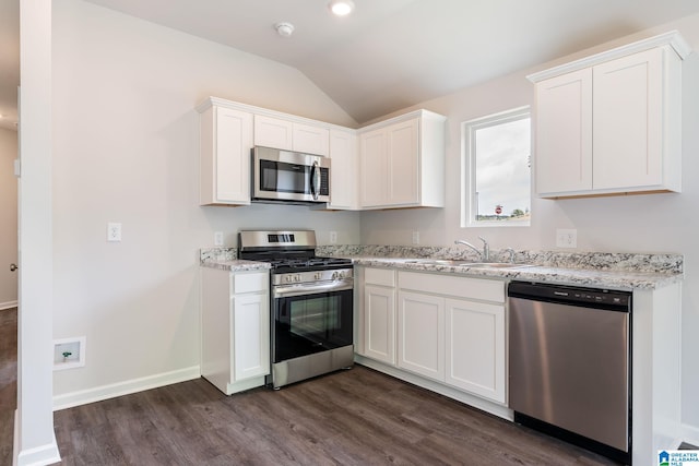 kitchen featuring light stone countertops, white cabinetry, dark hardwood / wood-style flooring, stainless steel appliances, and sink