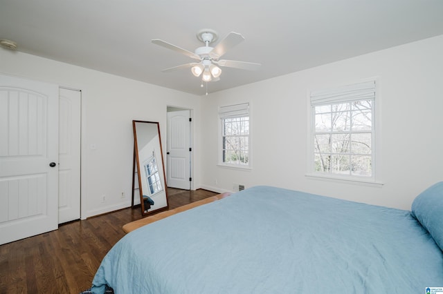 bedroom with dark hardwood / wood-style floors and ceiling fan