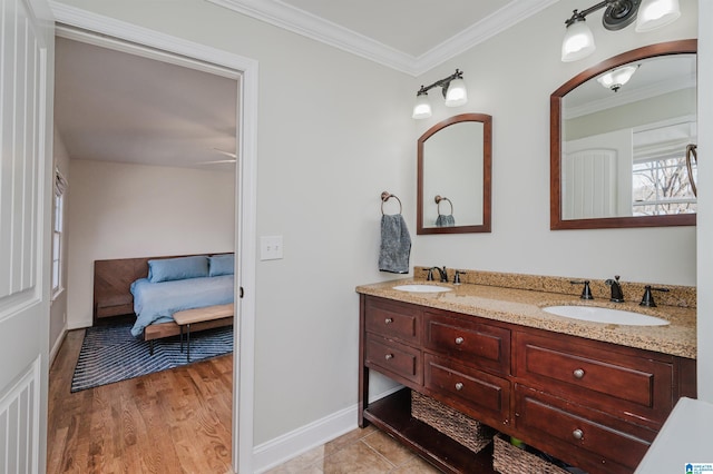 bathroom with hardwood / wood-style flooring, crown molding, and vanity