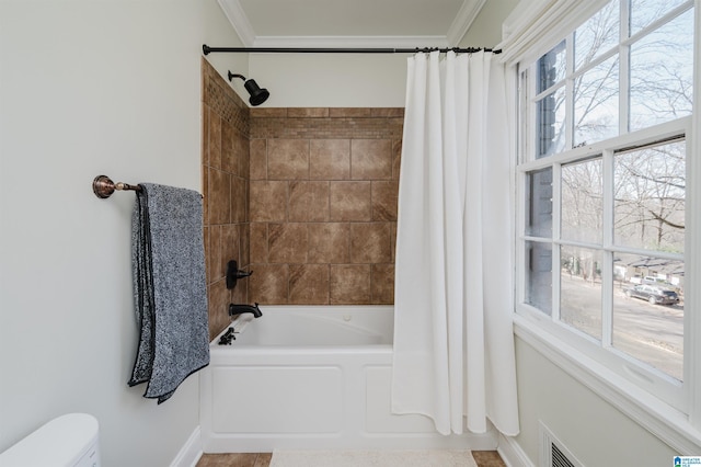 bathroom featuring crown molding and shower / tub combo