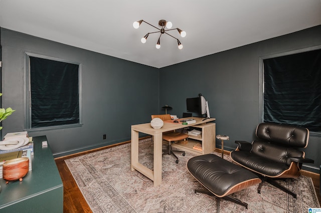 office with a notable chandelier and dark hardwood / wood-style floors