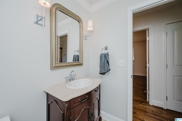 bathroom featuring vanity, hardwood / wood-style floors, and ornamental molding