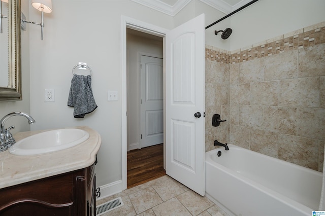 bathroom featuring crown molding, vanity, tiled shower / bath combo, and tile patterned flooring