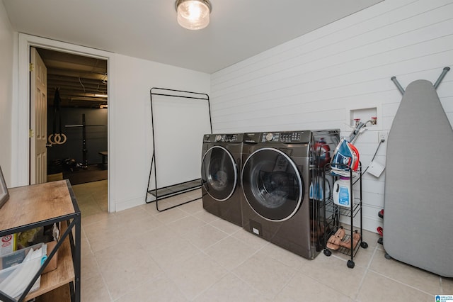 laundry room featuring light tile patterned flooring and separate washer and dryer