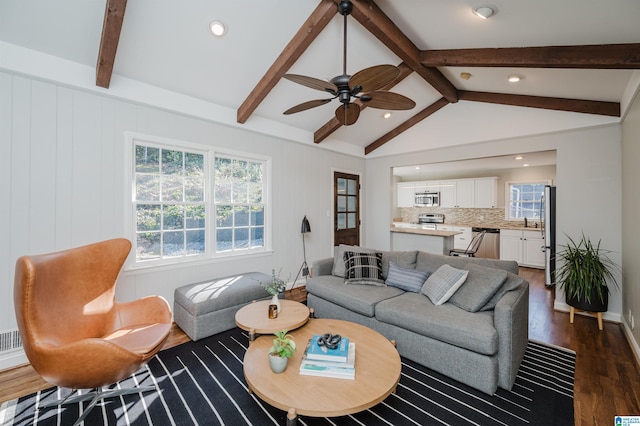 living room with sink, dark wood-type flooring, lofted ceiling with beams, and ceiling fan