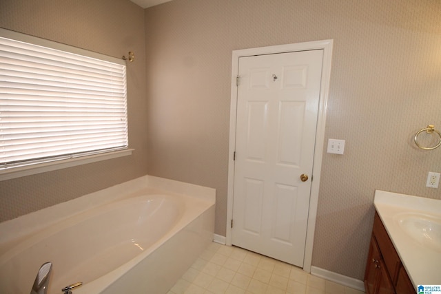 bathroom featuring vanity, a bathtub, and tile patterned floors