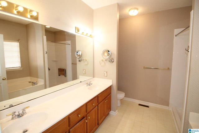 full bathroom featuring toilet, shower with separate bathtub, and vanity