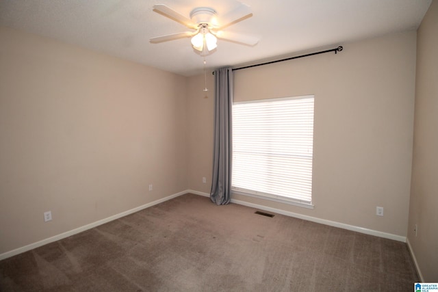 unfurnished room featuring ceiling fan and carpet