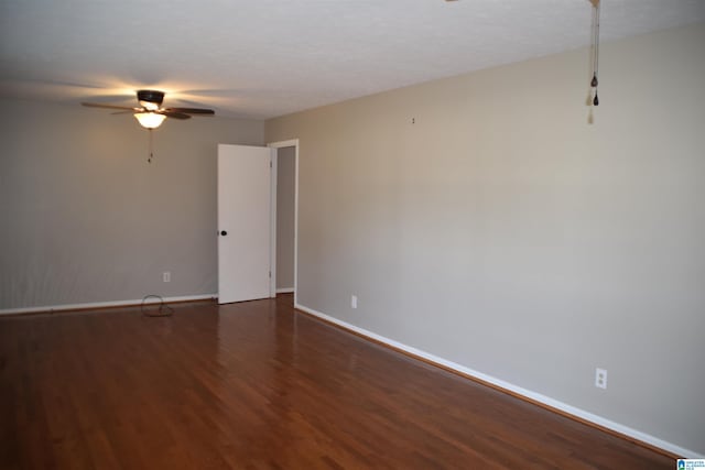 unfurnished room with ceiling fan and dark hardwood / wood-style flooring