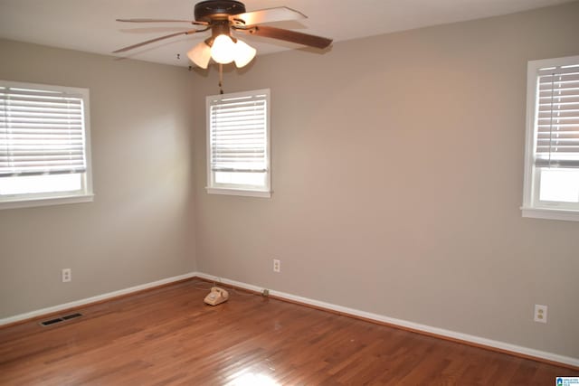 empty room featuring ceiling fan and hardwood / wood-style floors