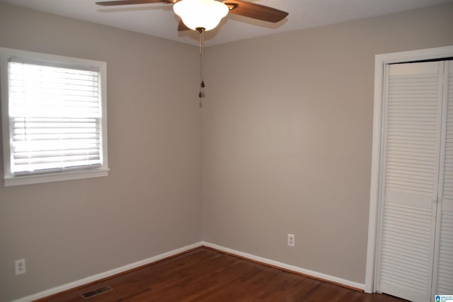 spare room with ceiling fan and dark hardwood / wood-style floors