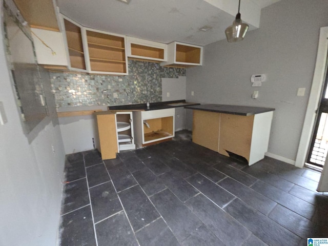 kitchen featuring backsplash and hanging light fixtures