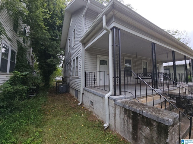 view of property exterior featuring covered porch