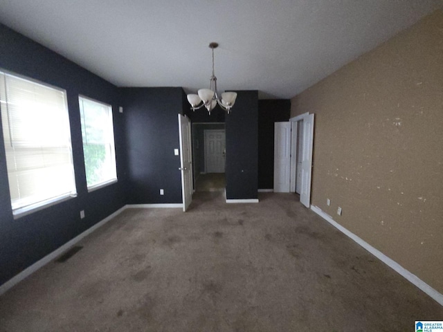 unfurnished dining area with an inviting chandelier and carpet floors