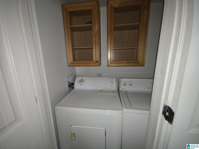 laundry area featuring cabinets and washing machine and dryer