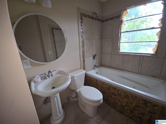 full bathroom featuring sink, toilet, tile patterned floors, and tiled shower / bath