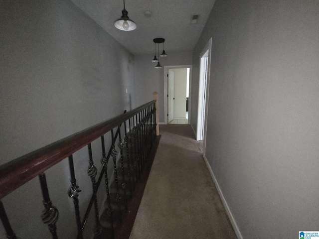 corridor with dark colored carpet