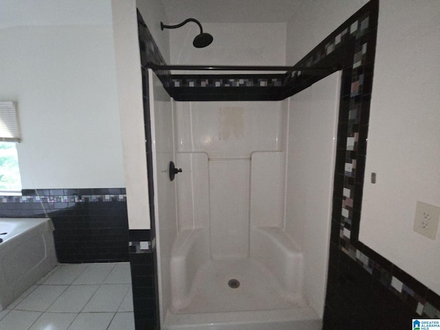 bathroom with a shower and tile patterned flooring