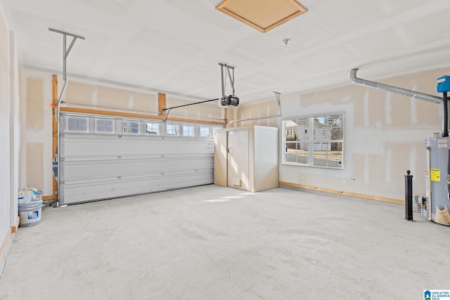 garage featuring a garage door opener and water heater