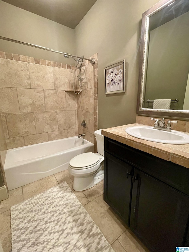 full bathroom featuring vanity, tiled shower / bath combo, tile patterned floors, and toilet