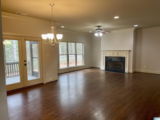 unfurnished living room featuring dark hardwood / wood-style flooring, crown molding, a premium fireplace, and french doors