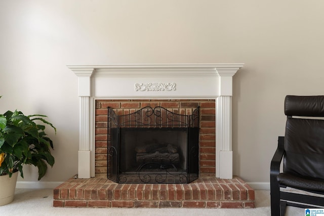 room details featuring a brick fireplace and carpet